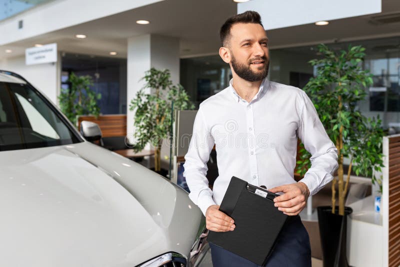 Sales Manager In A Car Dealership Hands Over The Keys And Documents To The Car Stock Photo Alamy